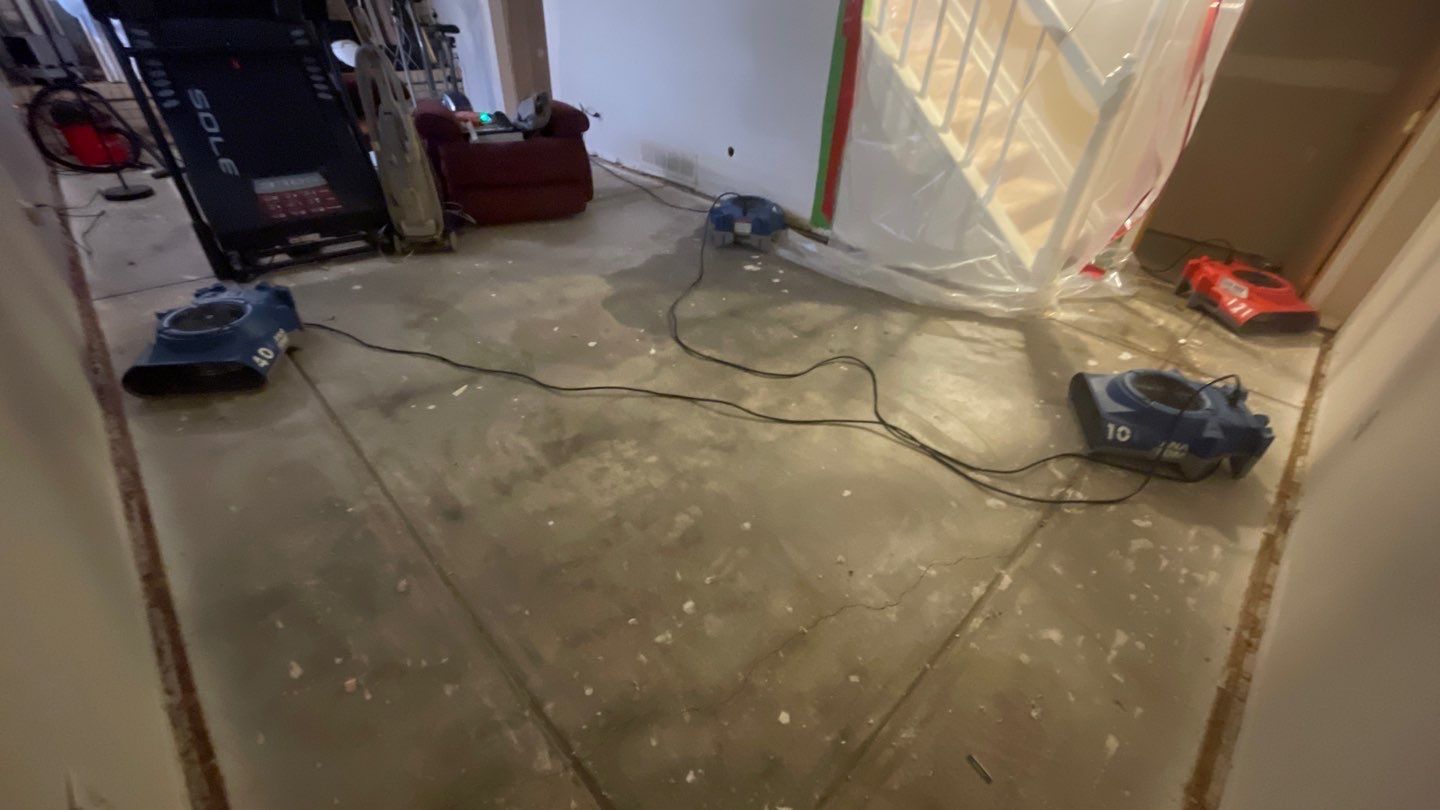 Air movers drying a concrete floor