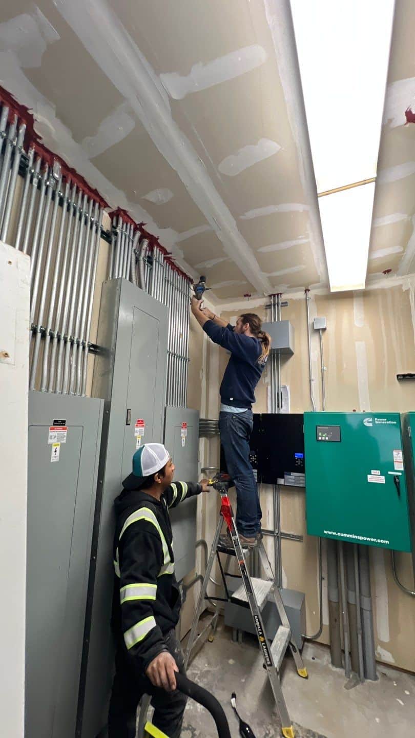 Workers installing electrical conduits