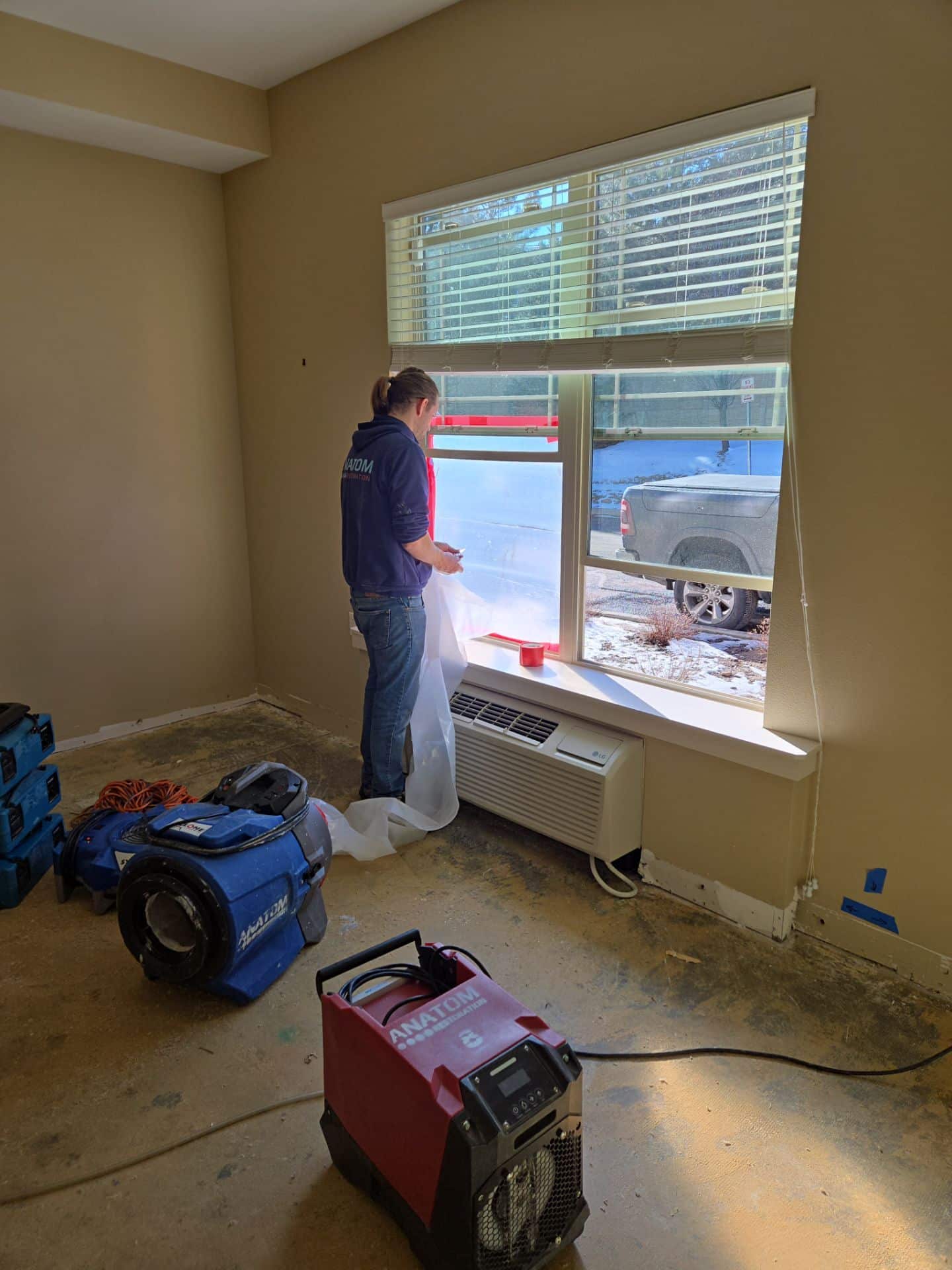 Worker sealing window with plastic