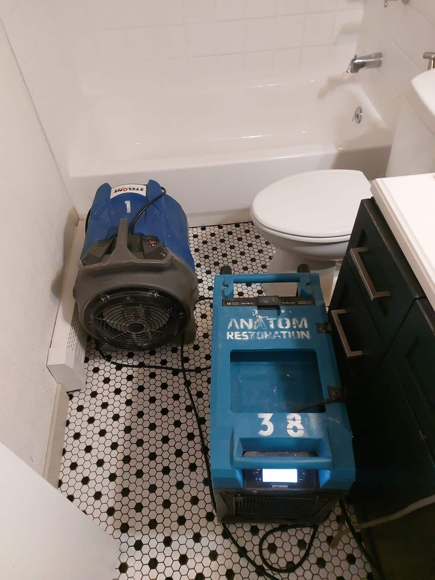 drying equipment from Anatom Restoration placed near a toilet