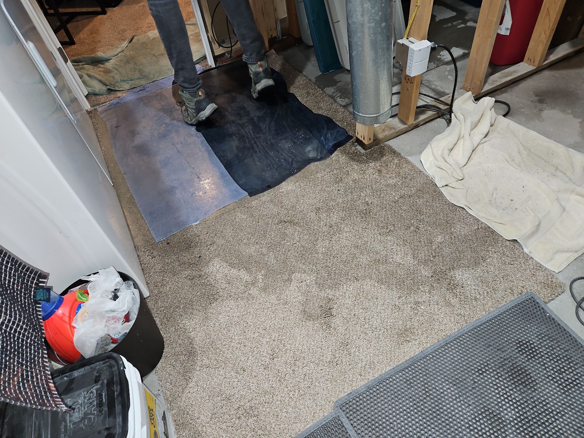 Wet carpet with towels and mats.