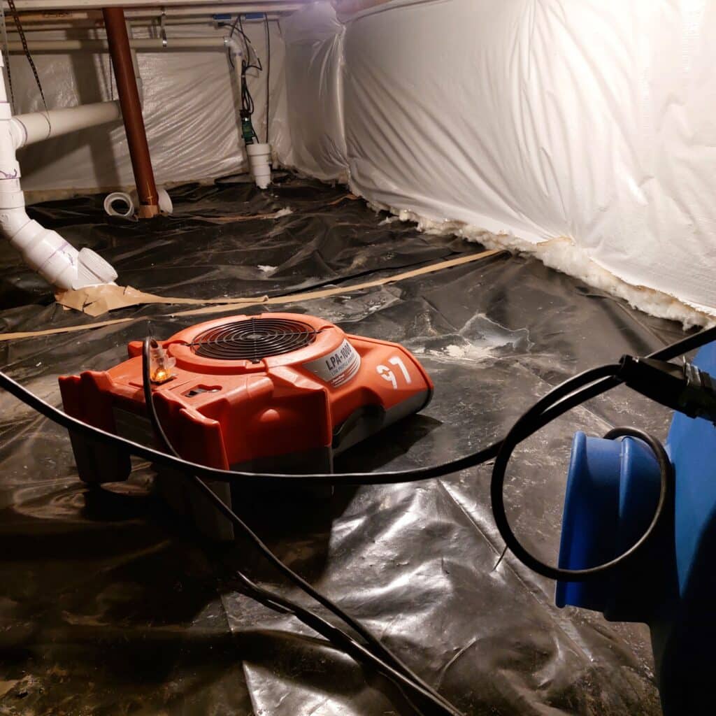 Air mover and drying equipment placed in a sealed crawl space.