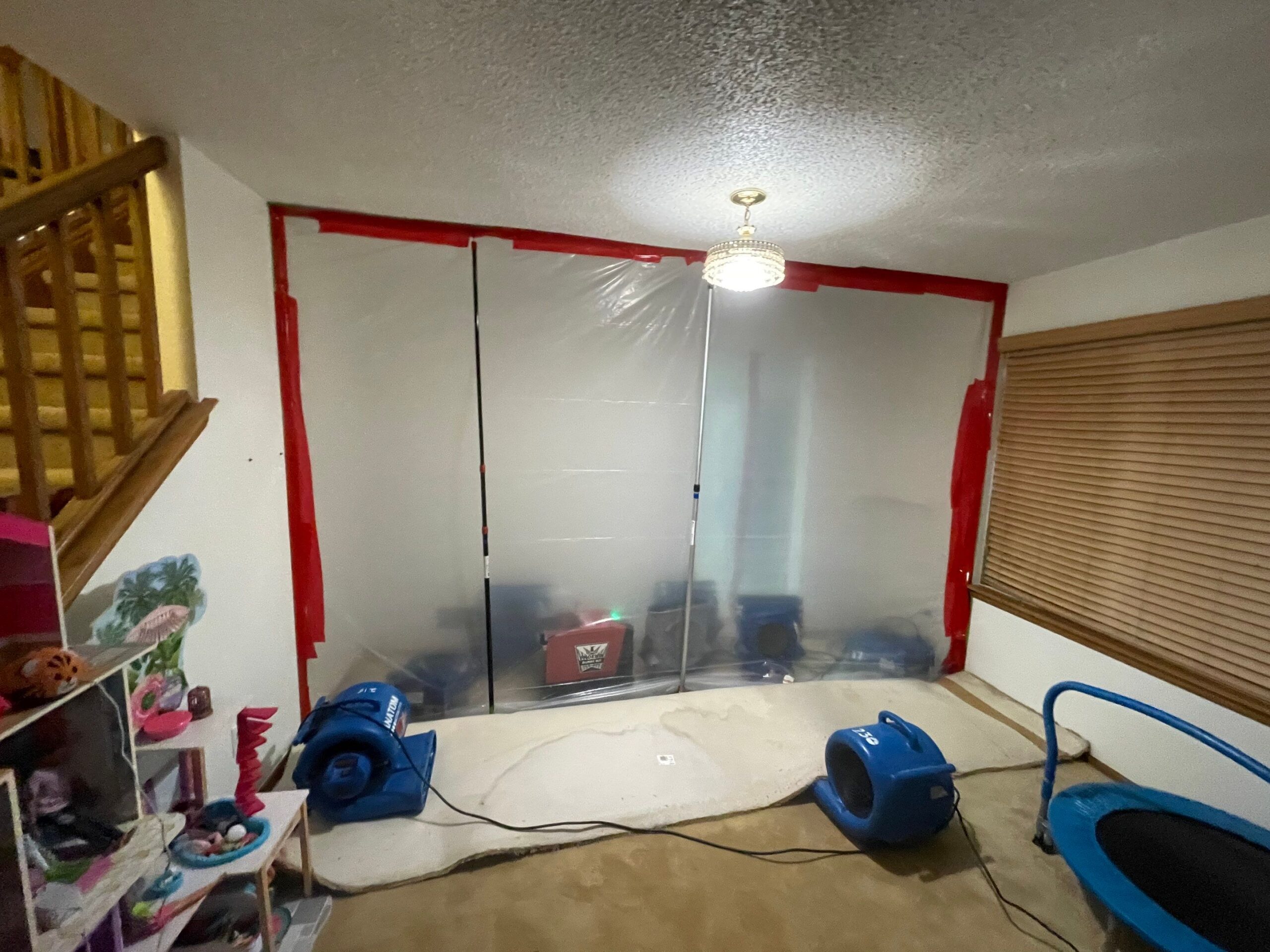 Containment area with drying equipment set up for water damage restoration.