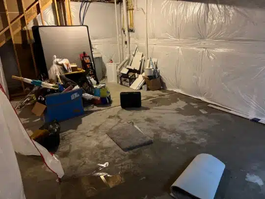 Flooded Basement with Water-Damaged Belongings Awaiting Restoration Cleanup