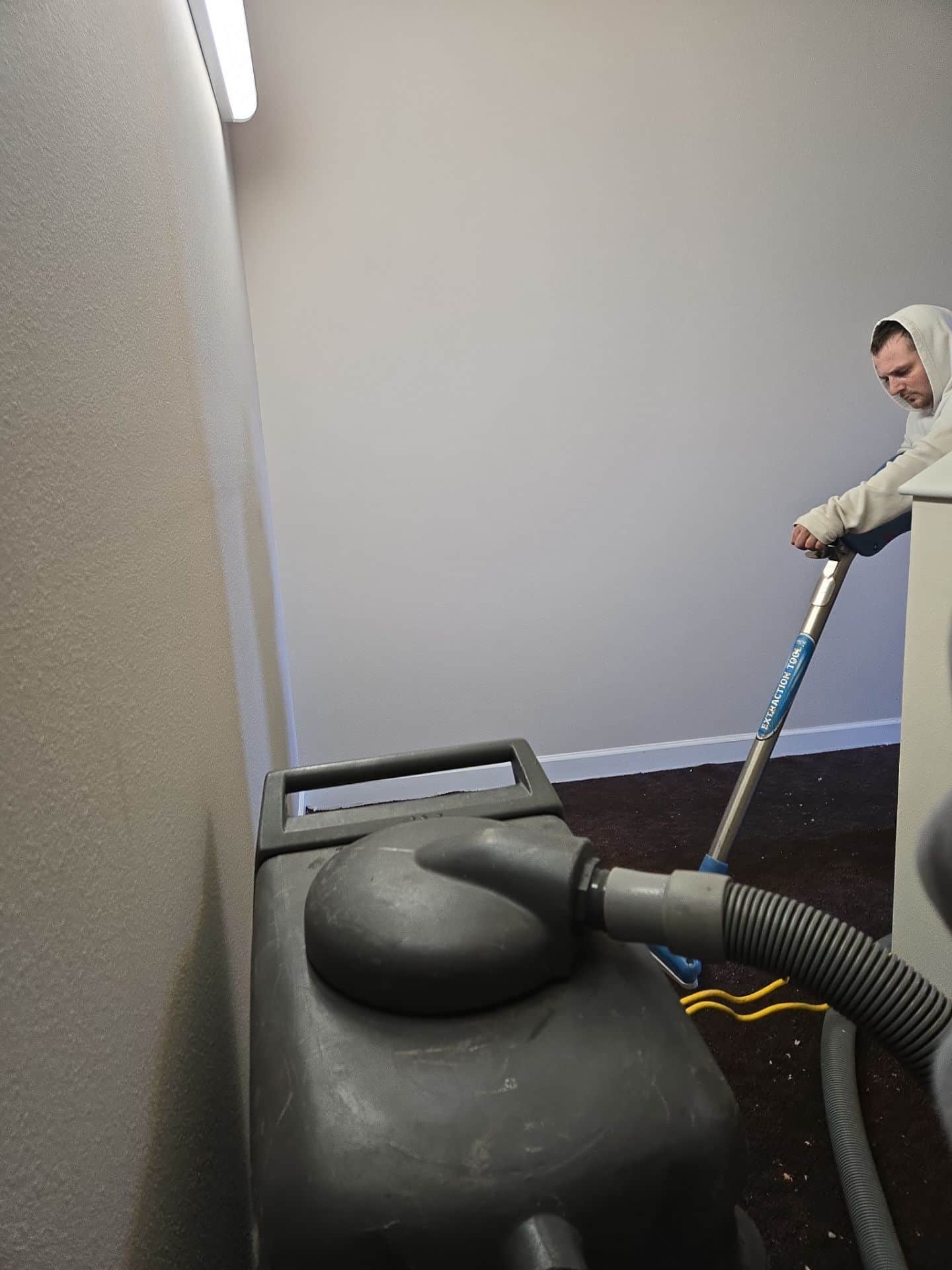 Worker using water extraction tool