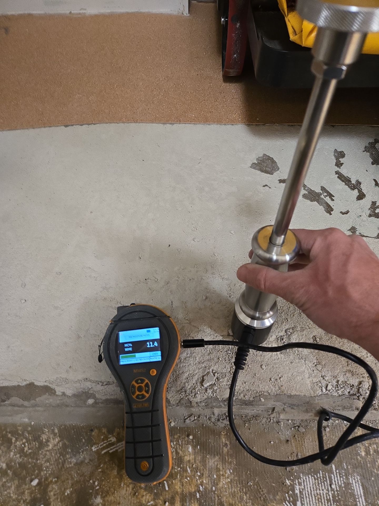 Moisture meter testing concrete