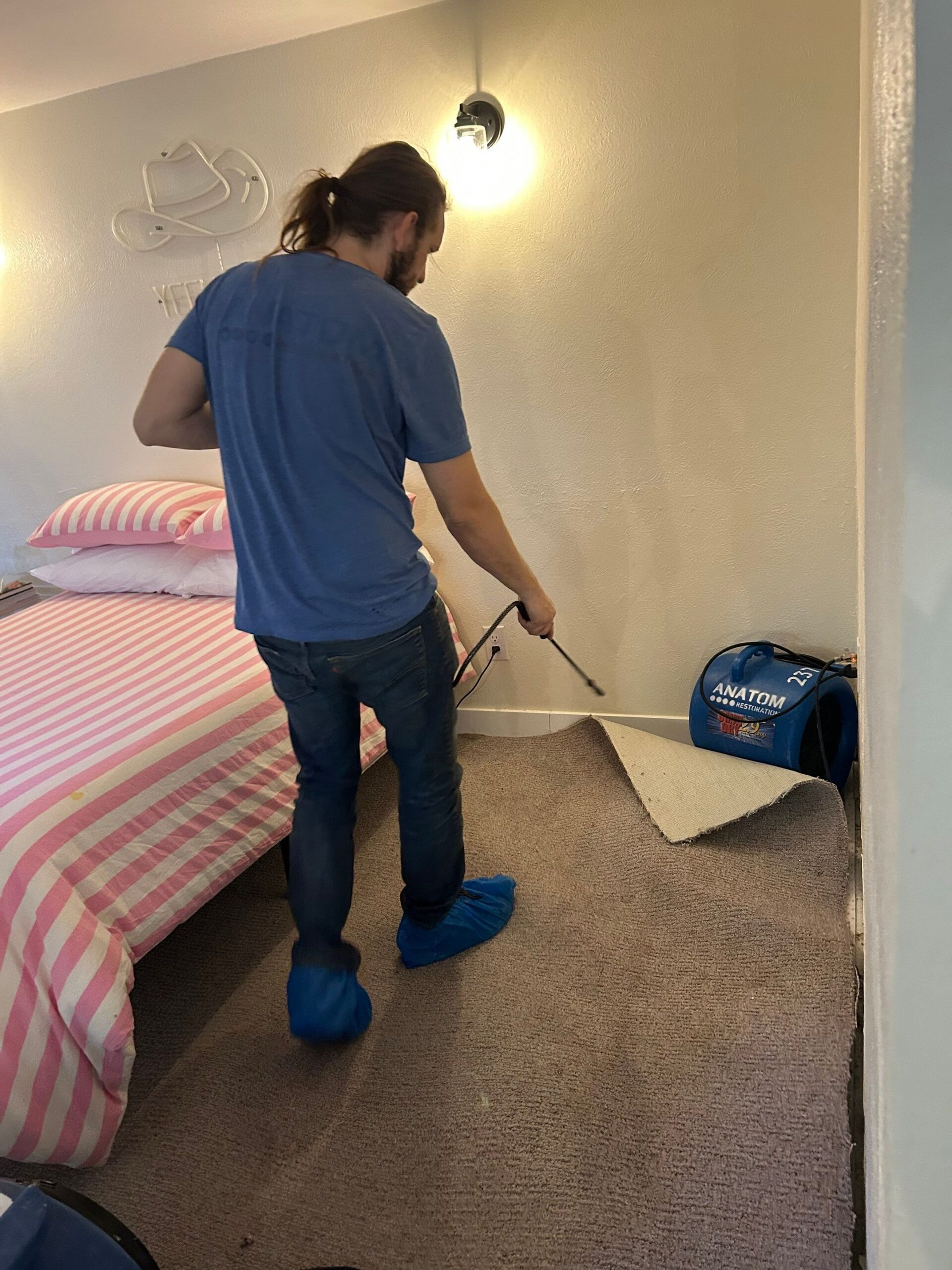 Technician inspecting wet carpet