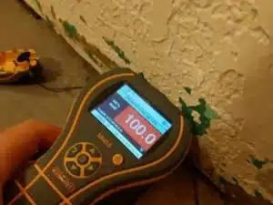 MMS2 Protimeter moisture meter displaying a reading.