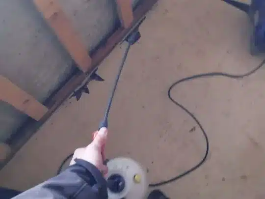 A person holding a cleaning tool is working on restoration