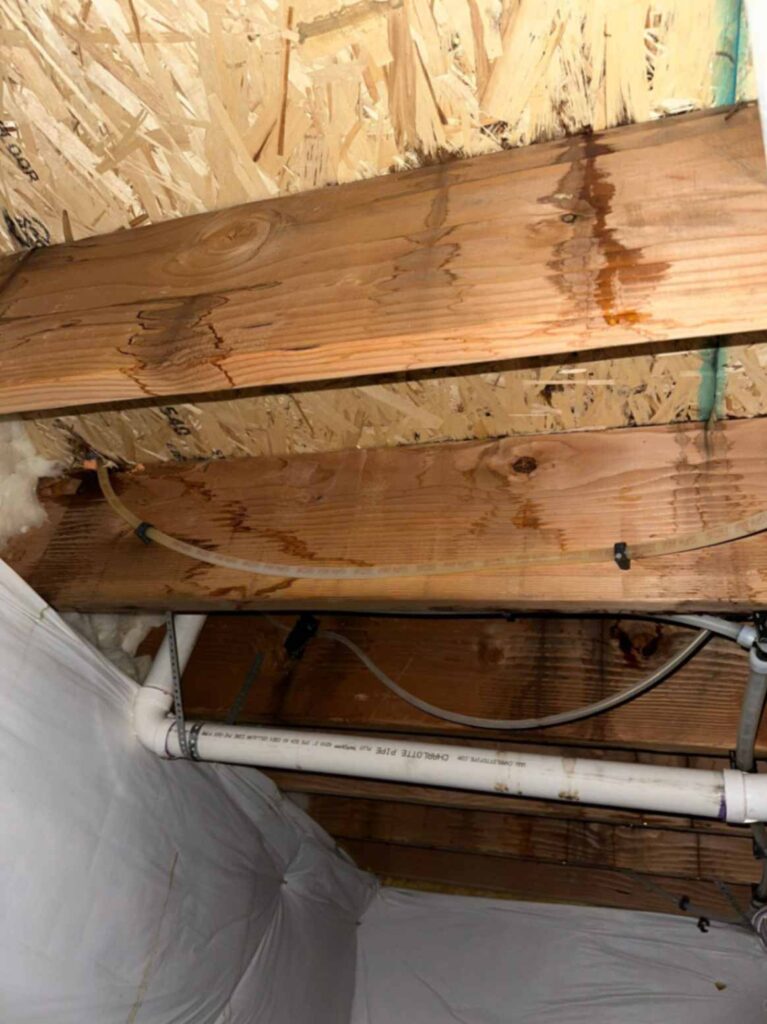 Water-damaged wooden beams from a leaking pipe