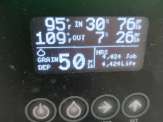 A close-up of a digital display showing moisture readings