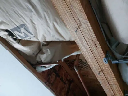 An angled view of wooden beams and insulation