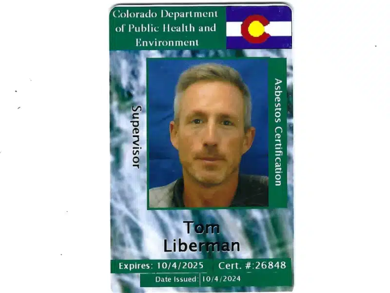 A supervisor-level asbestos certification ID card issued by the Colorado Department of Public Health and Environment, showing a headshot of a man against a blue background.