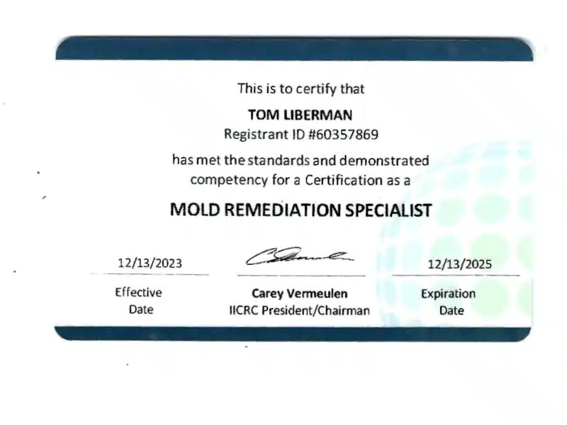 Certification card for a mold remediation specialist, showing a printed certificate with official signature and expiration date.