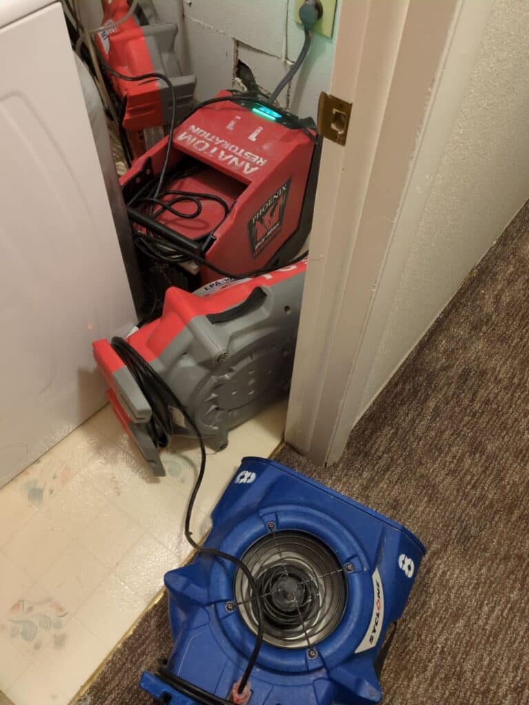 Water damage drying equipment set up inside a Denver home after moisture intrusion